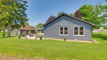 Relax on the inviting front porch, surrounded by mature trees and a serene atmosphere.