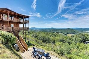 A wooden cabin with a balcony and a fireplace, surrounded by a forested landscape. - 'mountain Sky Escape' Murphy Cabin w/ Mtn Views (Murphy)
