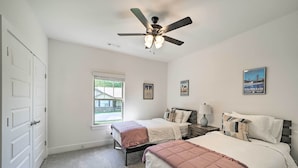 A bedroom with two beds, a ceiling fan, a window, and a door. - New Everything! Comfy Home w/ Deck & Trail Access! (Bella Vista)