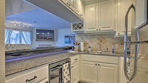 A modern kitchen with white cabinets, granite countertops, and stainless steel appliances. - Modern Townhome w/ Patio, Next Door to Resort (Horseshoe Bay)