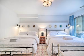 A bedroom with two beds, a patterned rug, and a small wooden nightstand with a lamp. - Pine Mountain Cabin w/ Hot Tub, 2 Mins to Marina! (Groveland)