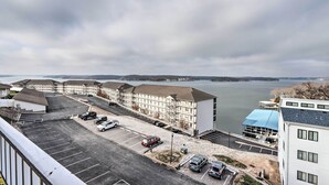 Un hotel de varios pisos con estacionamiento y vistas a un lago.