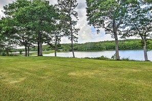 A grassy area with trees and a lake. - Ocean Inlet Cottage w/ Deck & Grill! (Bath)