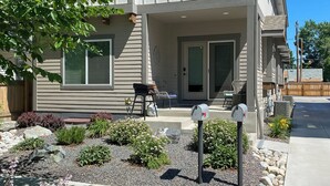 Ein Wohnhaus mit Veranda, Briefkasten und Garten.