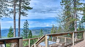 A wooden deck with a metal railing overlooking a mountainous landscape. - Near Hiking: Home w/ Deck in Twain Harte! (Mi-Wuk Village)