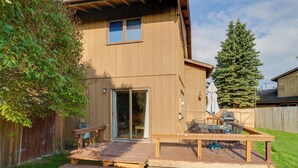 A wooden house with a deck, a sliding glass door, and a barbecue area. - Charming Anchorage Home w/ Grill + Deck! (Anchorage)