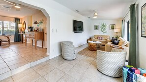A spacious living area with a sofa set, a coffee table, and a dining area with a table and chairs. - 8 Mi to Charlotte Sports Park: Home w/ Gulf Access (Port Charlotte)