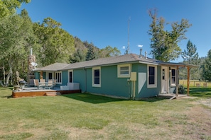 A small house with a covered porch, a barbecue grill, and a satellite dish. - Dolores Ranch Cabin w/ Hot Tub & 1-acre Yard! (Dolores)