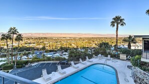 A pool area with lounge chairs, a view of a desert landscape, and a clear sky. - Mtn-view Balcony + Pool Access: Palm Springs Gem (Palm Springs)