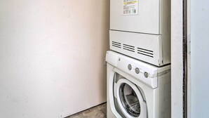 A stacked washer and dryer unit against a plain wall. - Odessa Apartment Near Parks, Shops & Dining! (Odessa)