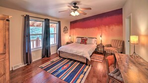A bedroom with a bed, a chair, a desk, a ceiling fan, and a window with curtains. - 'hilltop Hideout' w/ Peaceful Mountain Views (Mora)