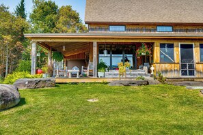 A wooden house with a covered porch, large windows, and a well-maintained lawn. - Porch & Countryside Views! Greensboro Home (Stannard)