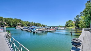 A marina with docked boats, a wooden pier, and a clear blue sky. - Keowee Keys Condo w/ Resort Amenities Access! (Salem)