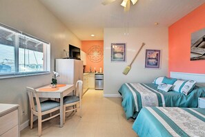 A compact bedroom with a bed, bedside table, and a window with blinds. - Everglades Studio W/marina View, Patio+pool Access (Naples)