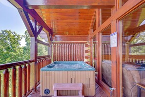 A wooden deck with a hot tub, wooden railings, and a bench. - Sensational Sunset! Sevierville Home w/ Hot Tub (Sevierville)