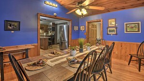 A dining area with a wooden table, chairs, and a ceiling fan. - Altmar Family Home w/ Rivers & Trails Nearby! (Altmar)