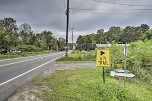 A rural road with a sign indicating an ATV trail to the right. - Altmar Family Home w/ Rivers & Trails Nearby! (Altmar)