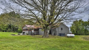 A house with a large tree in front, a red-roofed barn, and a white water tank. - Altmar Family Home w/ Rivers & Trails Nearby! (Altmar)