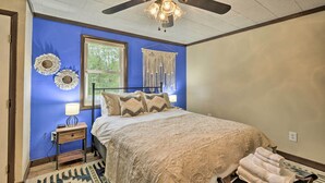 A bedroom with a bed, a ceiling fan, a window, and a nightstand. - Altmar Family Home w/ Rivers & Trails Nearby! (Altmar)