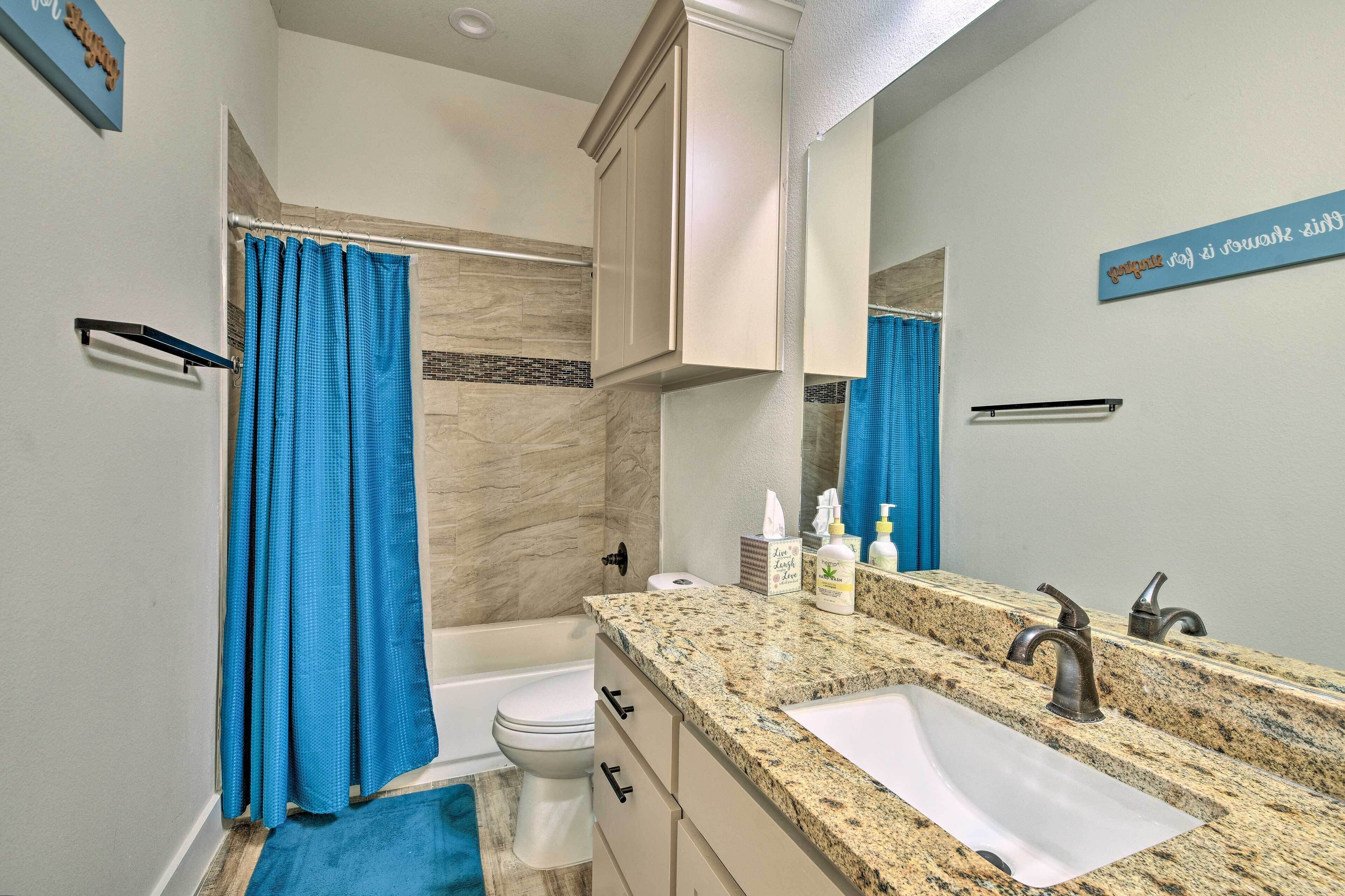 A bathroom with a bathtub, toilet, and sink.