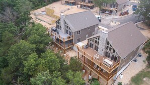 A large house with multiple decks and a covered patio area. - Lavish Retreat w/ Decks, Steps to Table Rock Lake! (Lampe)