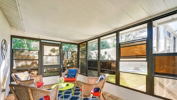 A covered patio with wicker furniture, a round table, and a patterned rug. - 7 Mi to Beaches: Pet-friendly Cape Coral Home (Cape Coral)