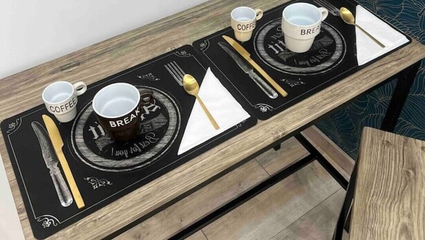 A breakfast tray with coffee cups and a spoon on a wooden table. - CaBi's Dreams (Napoli)
