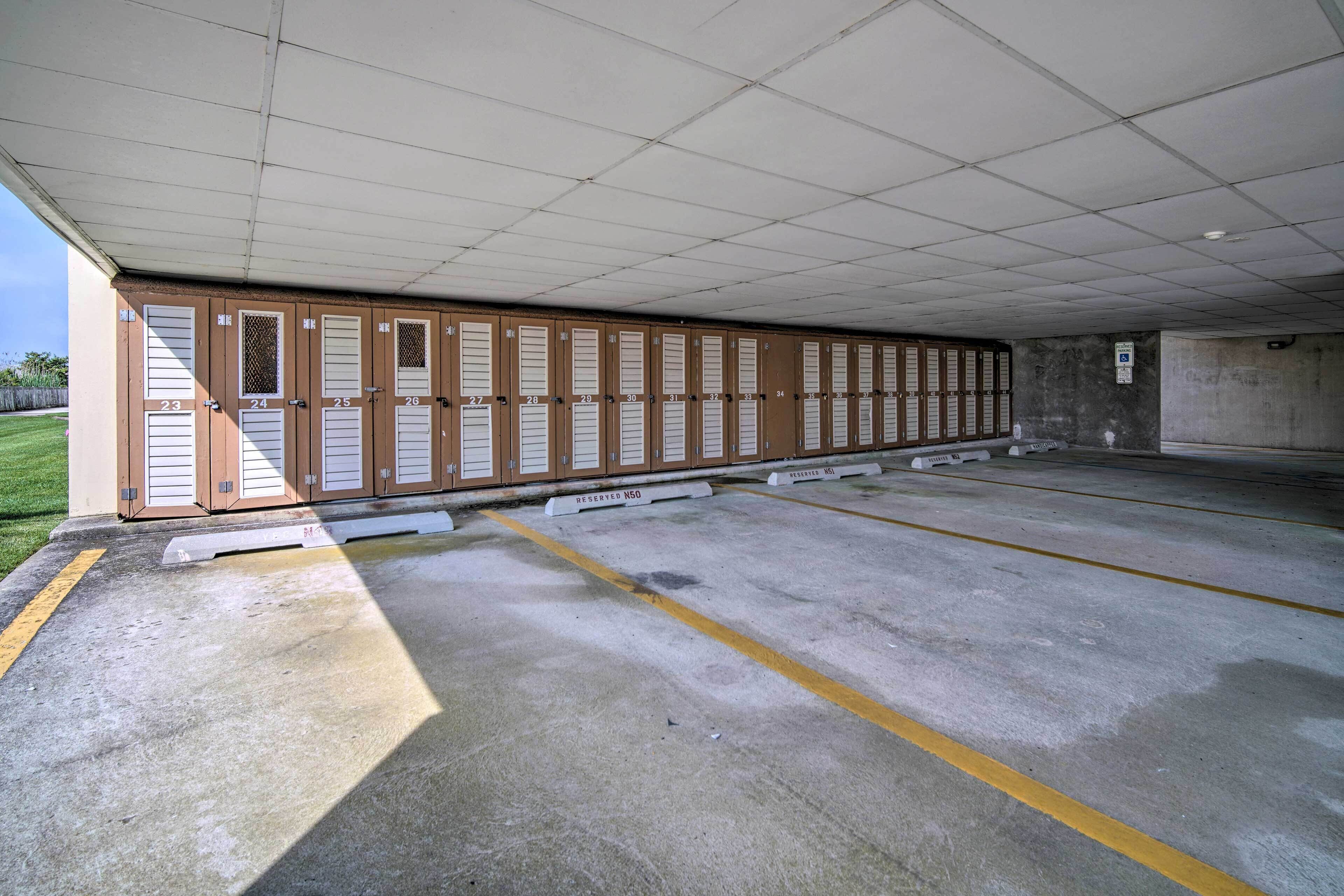 A row of numbered lockers under a covered area, with a concrete floor and yellow parking lines.