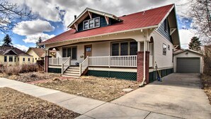 A two-story house with a red roof, a front porch, and a garage. - Laramie Home w/ Backyard < 1 Mi to Univ of Wyoming (Laramie)