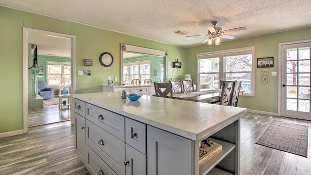 A kitchen with a large island, a ceiling fan, and a view into the dining area. - Pet-friendly Lake Buchanan Retreat w/ Fire Pit! (Tow)