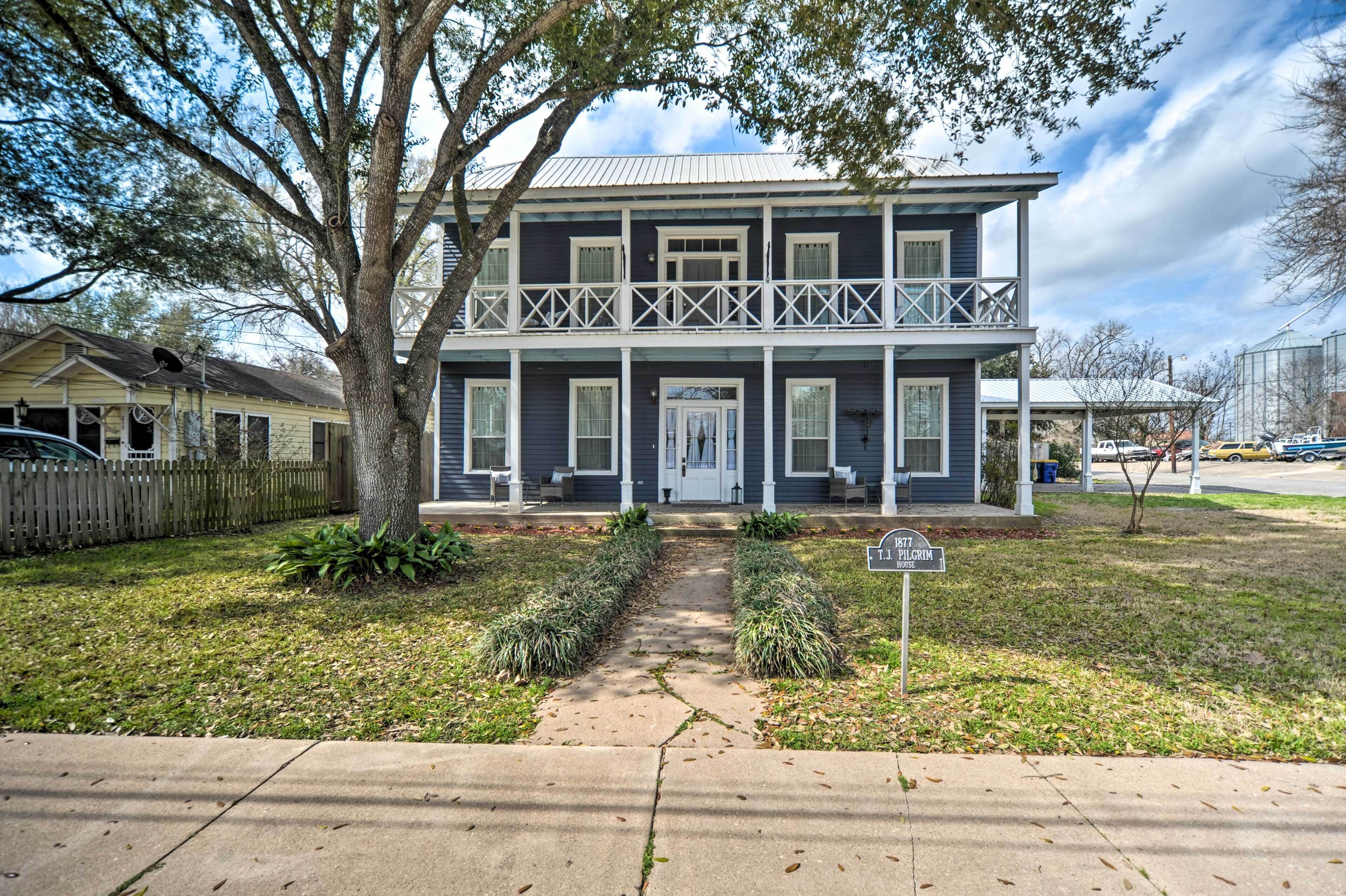 A two-story house with a front porch, a visible garage, and a well-maintained lawn.