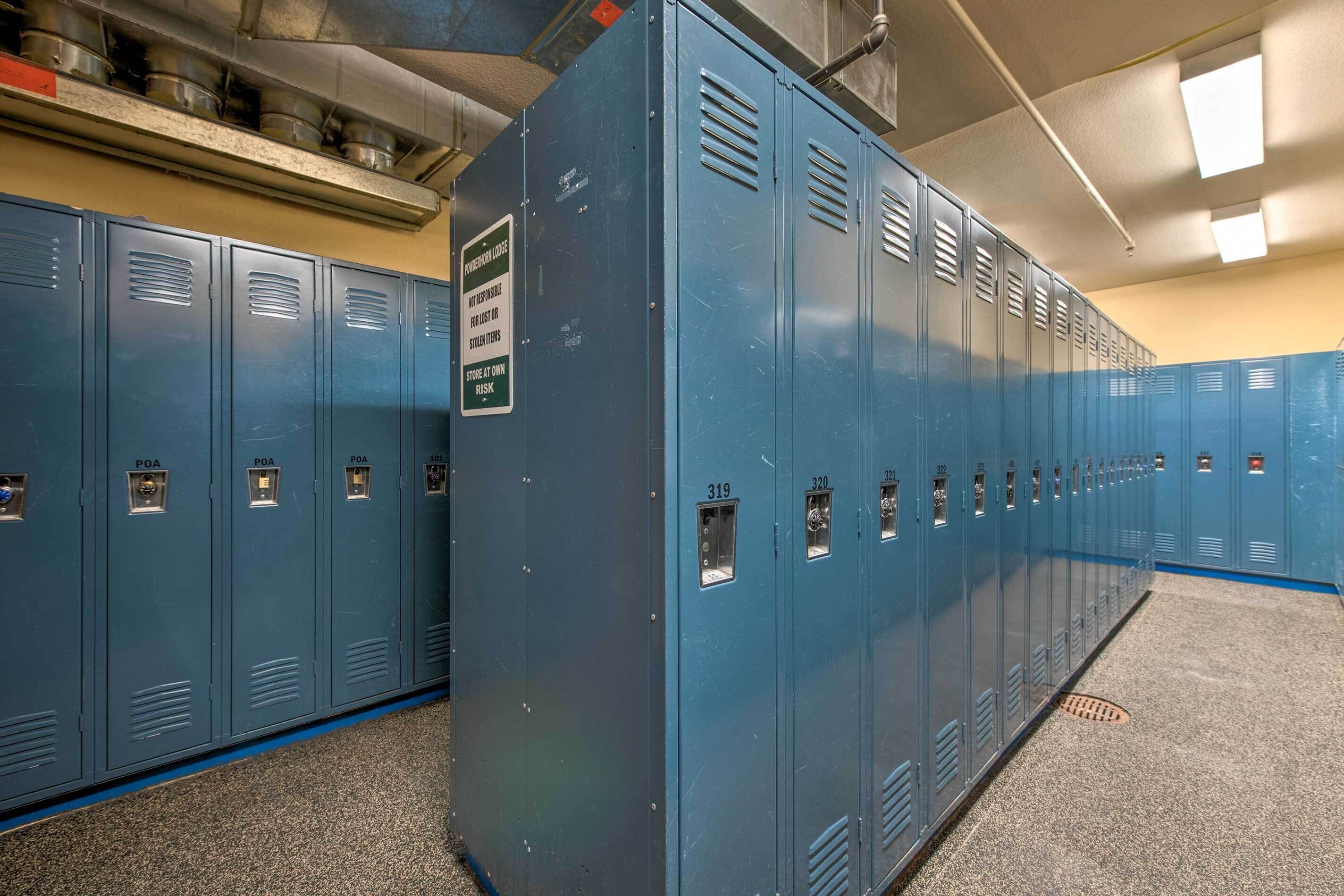 A row of blue lockers with ventilation slits and a sign warning against storing flammable items.