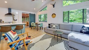 A modern living space with a kitchen, dining area, and seating area.