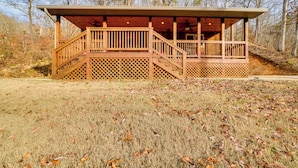 A wooden cabin with a covered porch and a staircase leading to an upper deck. - Cozy Waverly Cabin w/ Fireplace & Deck! (Waverly)