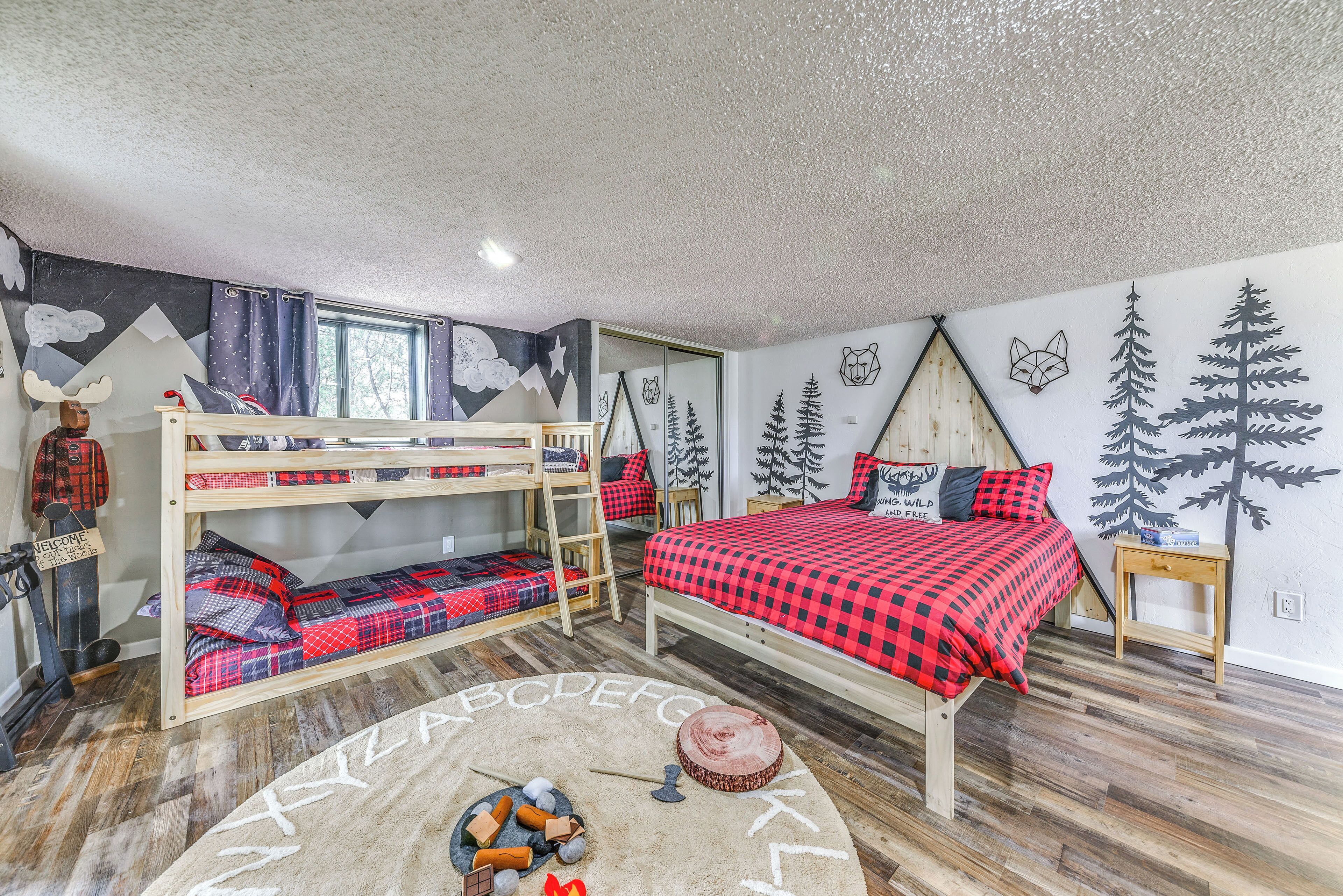 A cozy room with a bunk bed, a desk, and a window.