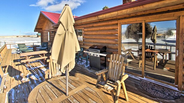 A wooden deck with a grill, chairs, and a table. - Secluded Dillon Home w/ Private Hot Tub + Deck! (Dillon)