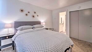 A bedroom with a bed, nightstands, a dresser, and a door. - Renovated Park City Condo: Hike, Bike & Ski! (Park City)