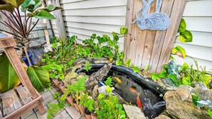 A garden with a pond, wooden structures, and various plants. - Pet-friendly Hudson Home: Boat Slip, Private Pool (Hudson)