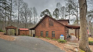 A rustic log cabin with a porch and a small shed. - Rural Murphy Cabin - Yard, Hot Tub & Fire Pit (Murphy)