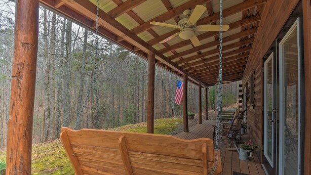 A wooden deck with a bench, a ceiling fan, and an American flag. - Rural Murphy Cabin - Yard, Hot Tub & Fire Pit (Murphy)