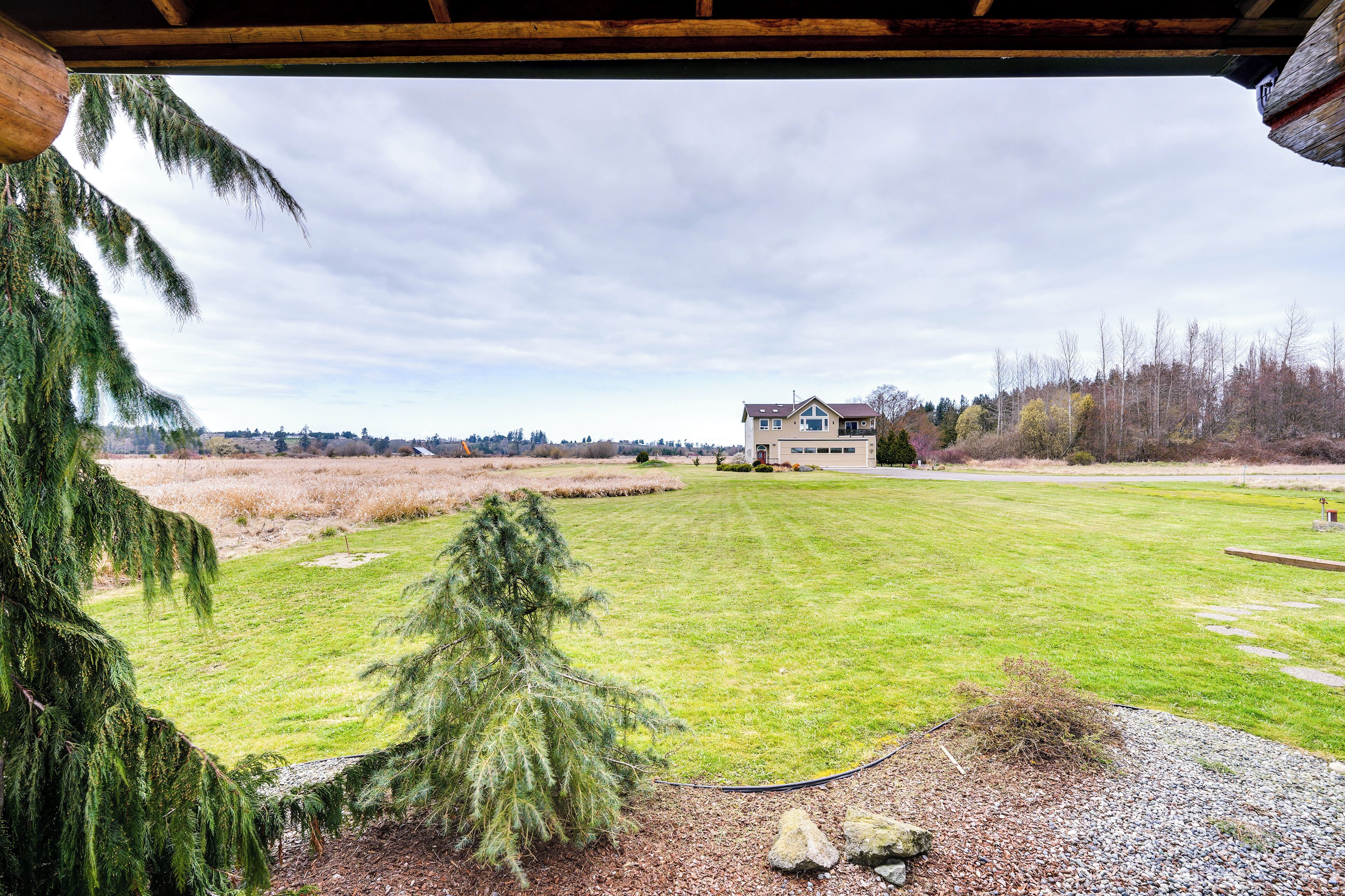 A house with a well-maintained lawn and a gravel path leading to the entrance.