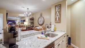 A kitchen with a Keurig coffee maker, a sink, and a clock on the wall. - Mtn-view Condo w/ Lookout Deck in Banner Elk! (Banner Elk)