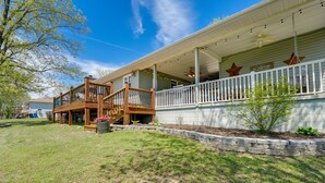 A two-story house with a porch, a wooden staircase, and a sign that reads "Welcome". - Charming Shell Knob Home: 16 Mi to Dogwood Canyon! (Shell Knob)