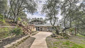 A two-story house with a covered patio, a stone pathway leading to the entrance, and a fenced garden area. - Shingle Springs Escape w/ Pool Near Casino! (Shingle Springs)