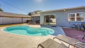 A backyard with a swimming pool, a covered patio, and a house with a sliding glass door. - Fire Pit! Family Getaway, 6 Mi to Beach Access (Largo)
