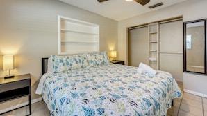 A bedroom with a bed, nightstands, a ceiling fan, a window, and a built-in wardrobe. - Fire Pit! Family Getaway, 6 Mi to Beach Access (Largo)