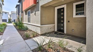 A residential building with a front entrance, a small garden area, and a clear pathway leading to the entrance.