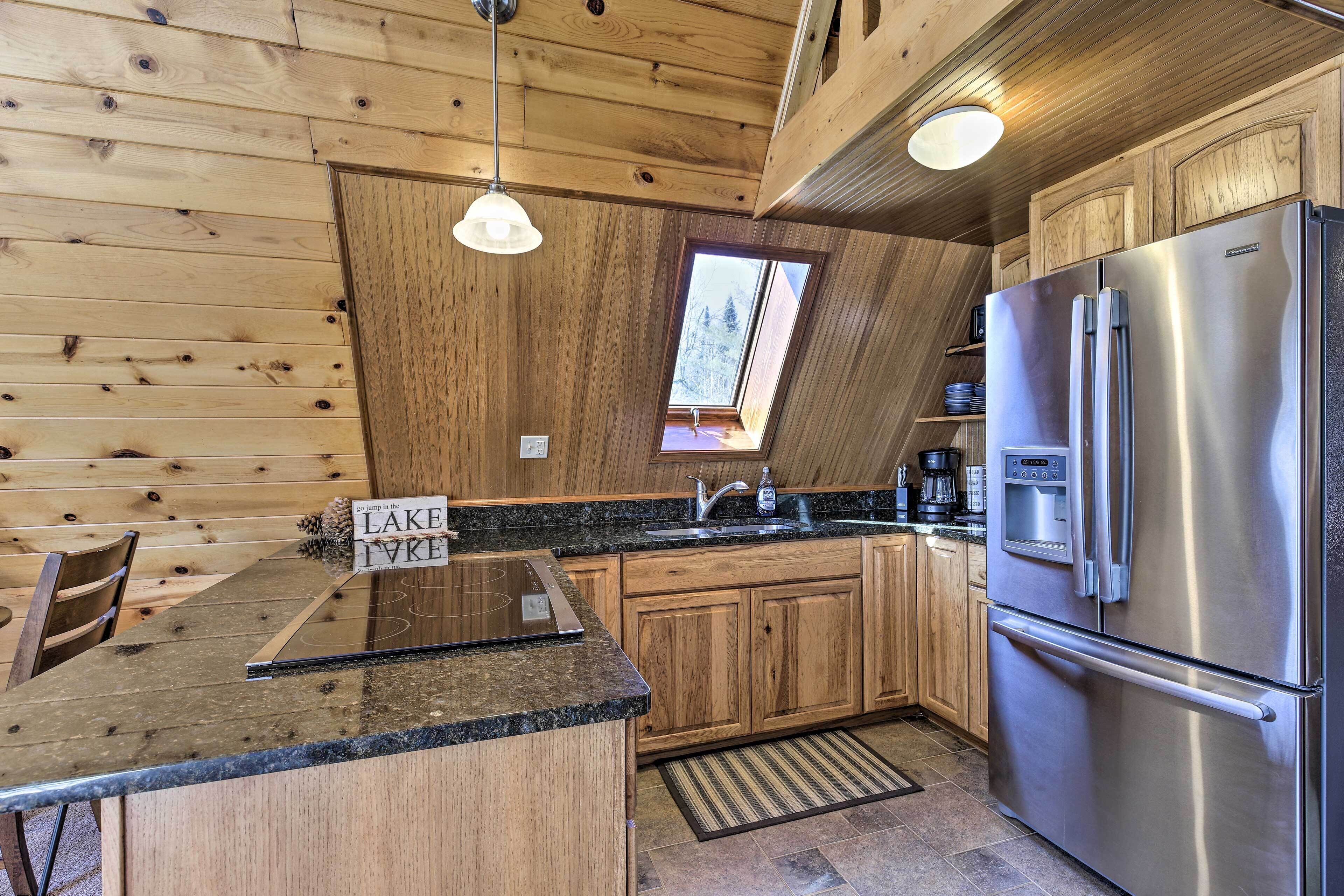 A kitchen with wooden walls, a stainless steel refrigerator, and a sign that reads 'LAKE IVRE'.