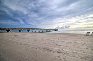 A beach with a pier extending into the water, a sandy shore, and a few lounge chairs. - 1 Mi to Deerfield Beach: Home w/ Outdoor Oasis! (Deerfield Beach)