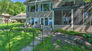 A two-story house with a balcony, large windows, and a fenced yard. - Pet-friendly Family Home Situated on Green Lake! (Green Lake)